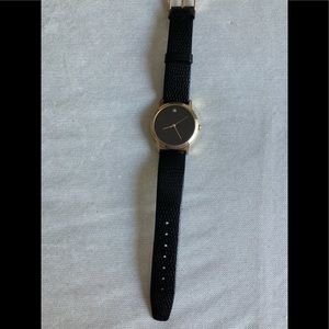 Men’s classic watch.  Black face and band.  With gold arms